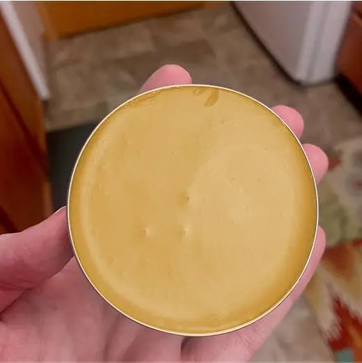 Open TheraWolf tin showing the balm texture